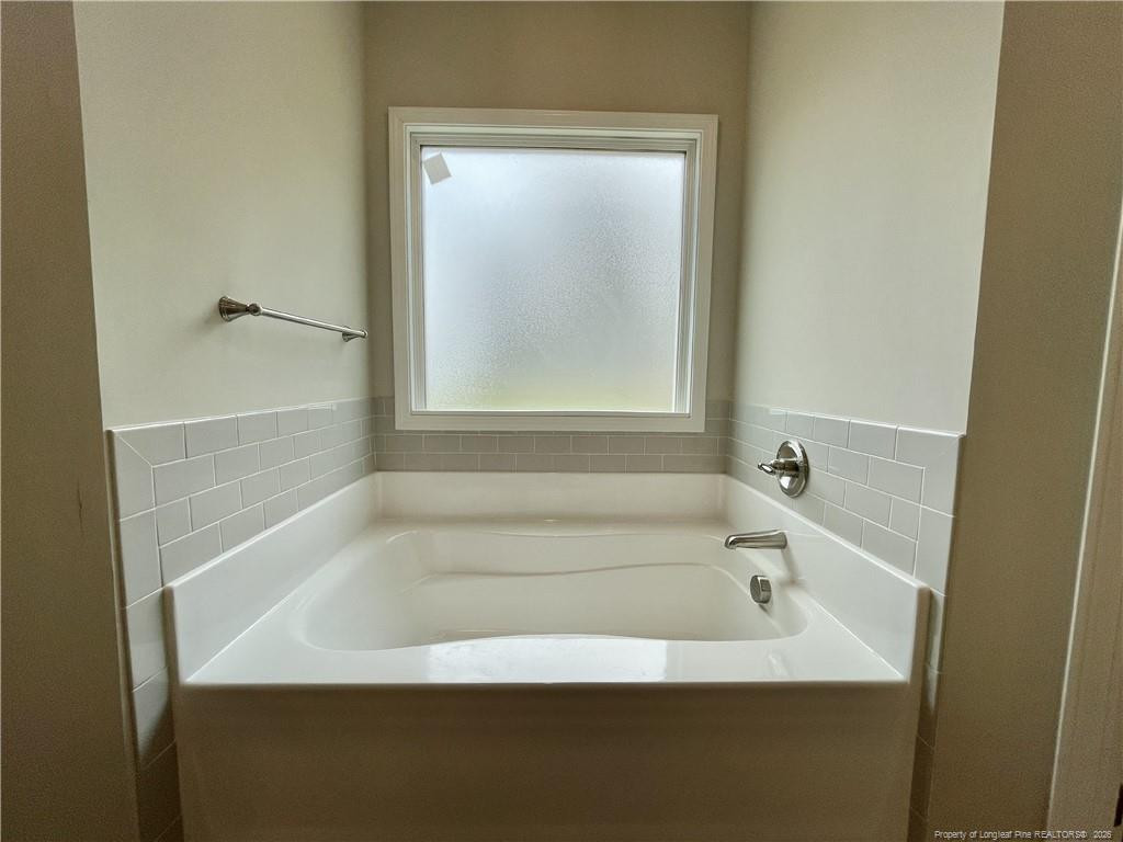 5177 Maxwell Road Stedman, NC 28391 - Photo 13 of 24 a white bath tub sitting next to a shower