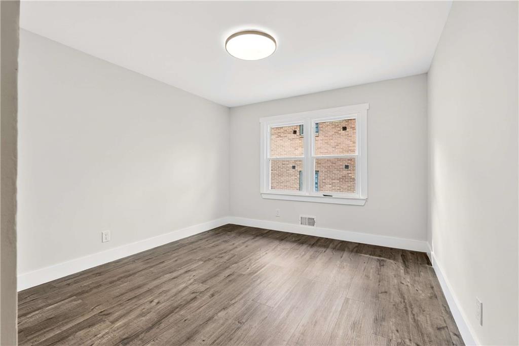 3292 Toney Drive Decatur, GA 30032 - Photo 15 of 28 an empty room with wooden floor and windows