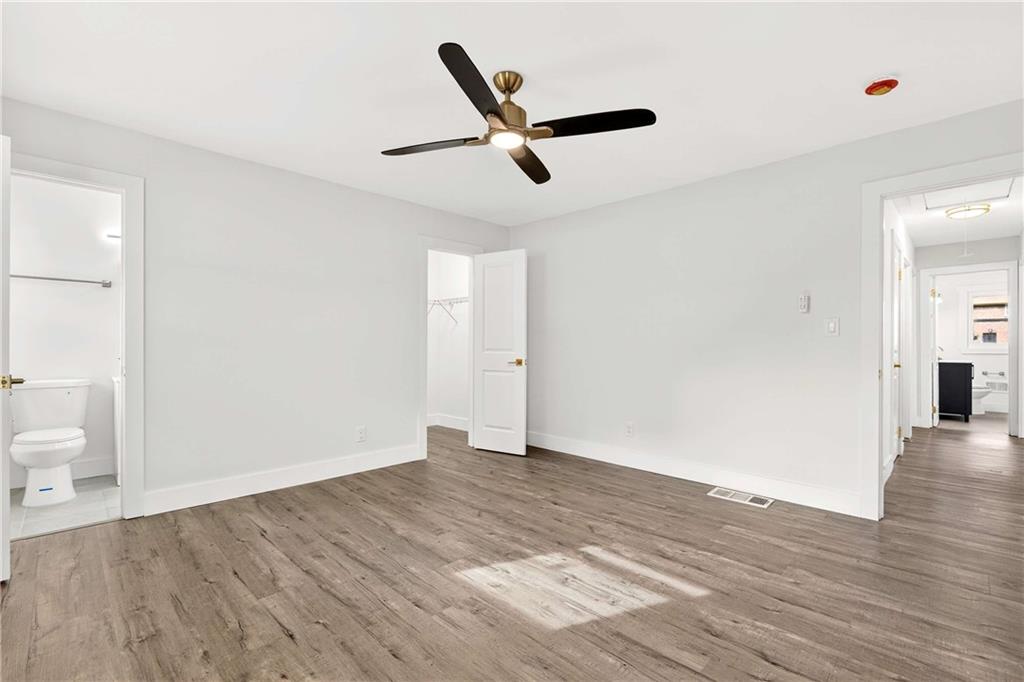 3292 Toney Drive Decatur, GA 30032 - Photo 16 of 28 a view of an empty room with wooden floor and a ceiling fan