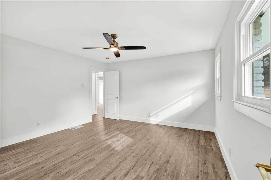 3292 Toney Drive Decatur, GA 30032 - Photo 19 of 28 an empty room with wooden floor and windows