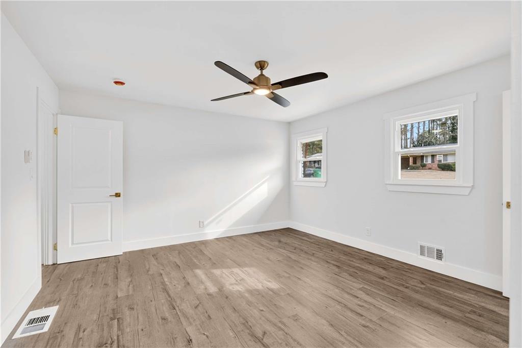 3292 Toney Drive Decatur, GA 30032 - Photo 20 of 28 a view of a big room with wooden floor and a ceiling fan