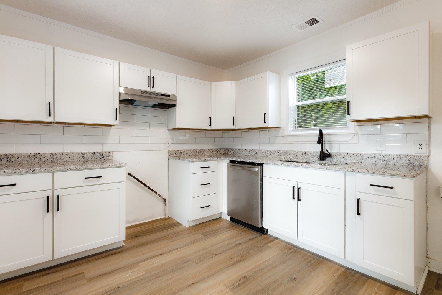 41 North Bingham Street Memphis, TN 38112 - Photo 4 of 9 a kitchen with granite countertop white cabinets and white appliances with wooden floor