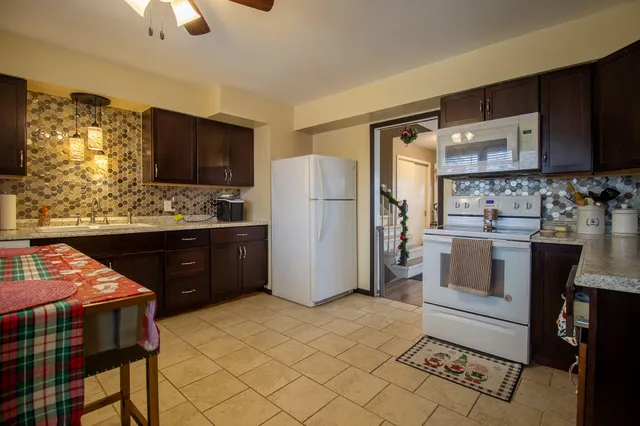 a kitchen with a stove a sink and a microwave