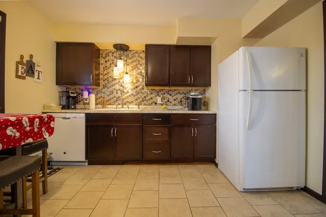 a kitchen with a stove and a wooden cabinets
