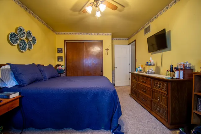 a bedroom with a bed and a chandelier