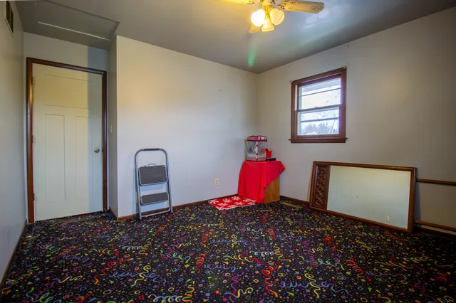 an empty room with windows and closet