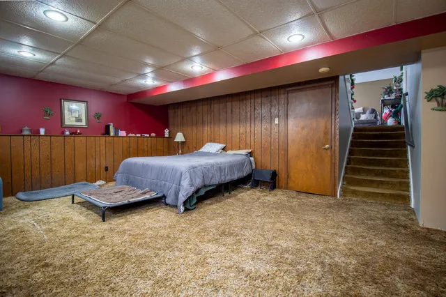 a bed room with a bed and a large window