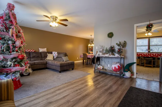 a living room with furniture and a chandelier