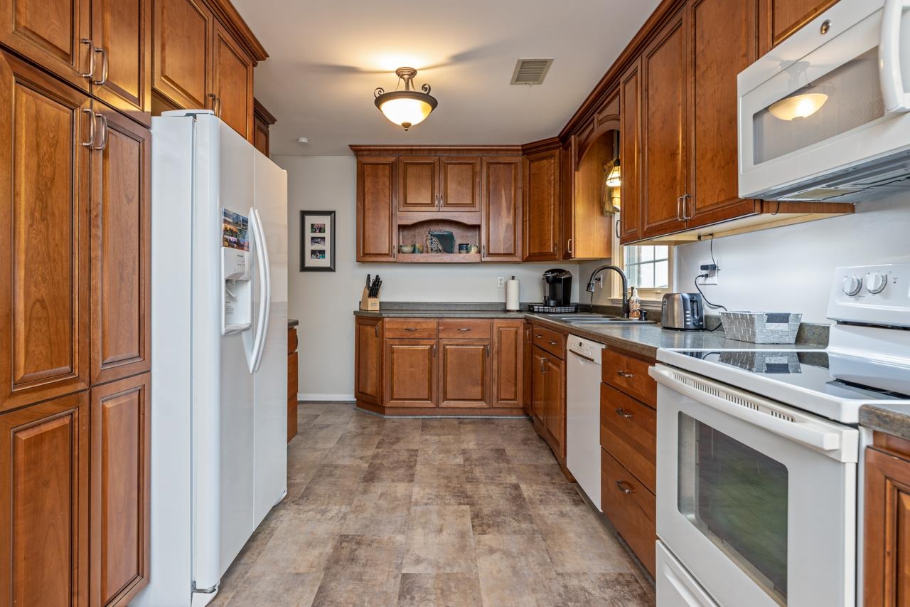 204 Robinhood Road Staunton, VA 24401 - Photo 8 of 46 a kitchen with stainless steel appliances granite countertop a stove a sink and a refrigerator
