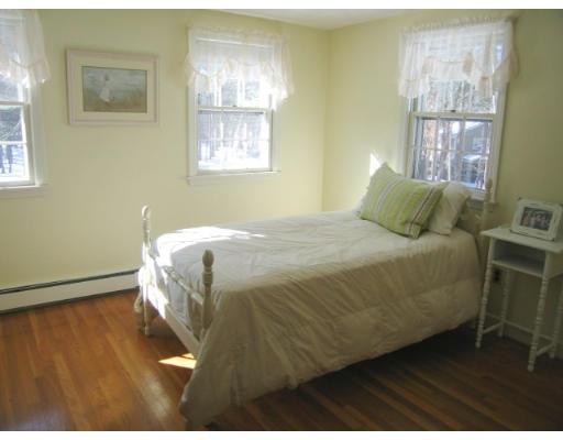505 Hayward Mill Road Concord, MA 01742 - Photo 11 of 12 a bedroom with a bed and wooden floor