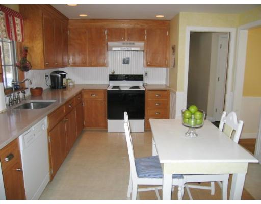 505 Hayward Mill Road Concord, MA 01742 - Photo 4 of 12 a kitchen with a sink a stove and chairs