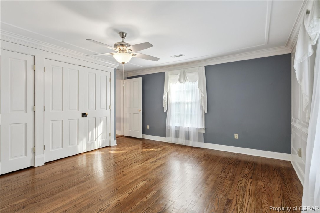 7175 Ware House Road Gloucester, VA 23061 - Photo 25 of 39 Hardwood floored bedroom with ornamental molding and ceiling fan