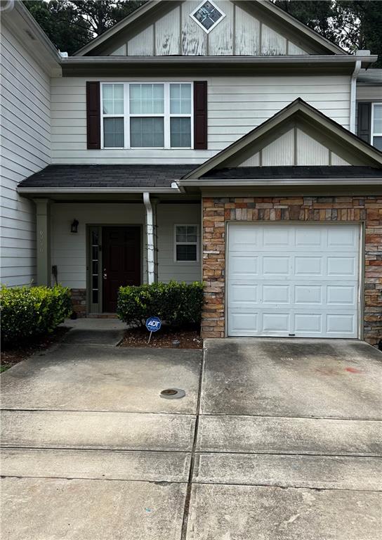 6956 Rogers Point Stonecrest, GA 30058 - Photo 1 of 1 a front view of a house with garden
