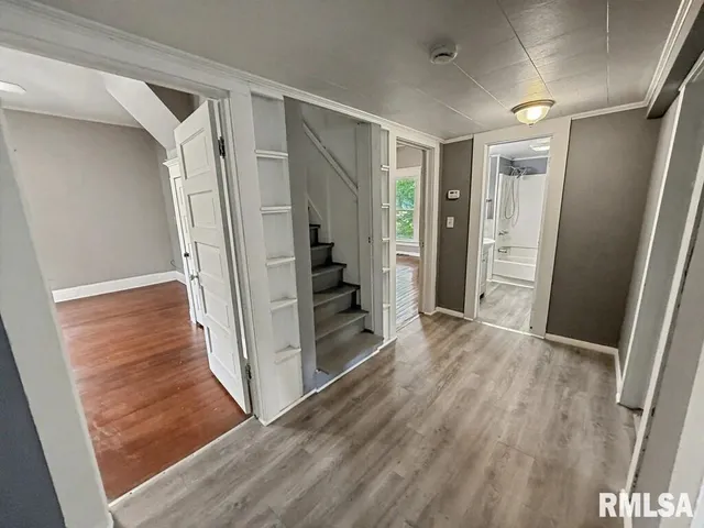 a view of entryway with wooden floor and staircase