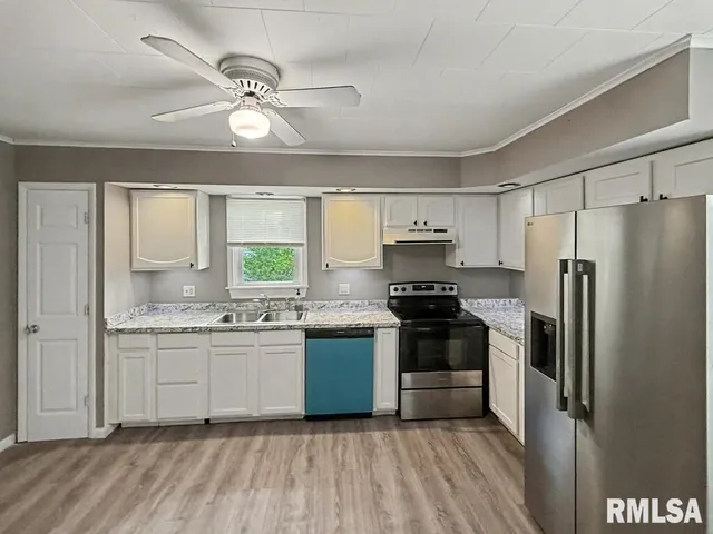 a kitchen with a sink stove and refrigerator