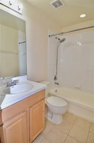 a bathroom with a sink toilet vanity and shower