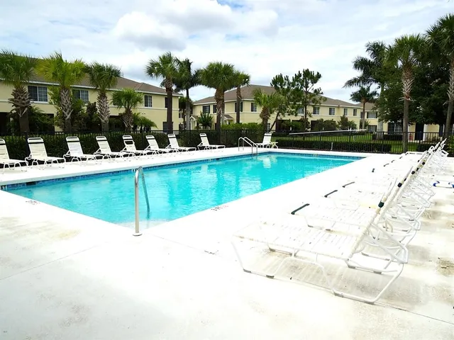 a view of a swimming pool with a lounge chairs