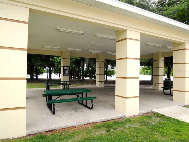 a swimming pool with outdoor seating and patio