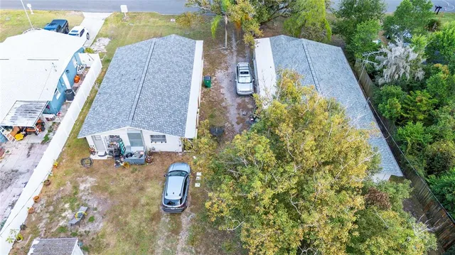 an aerial view of residential houses with outdoor space