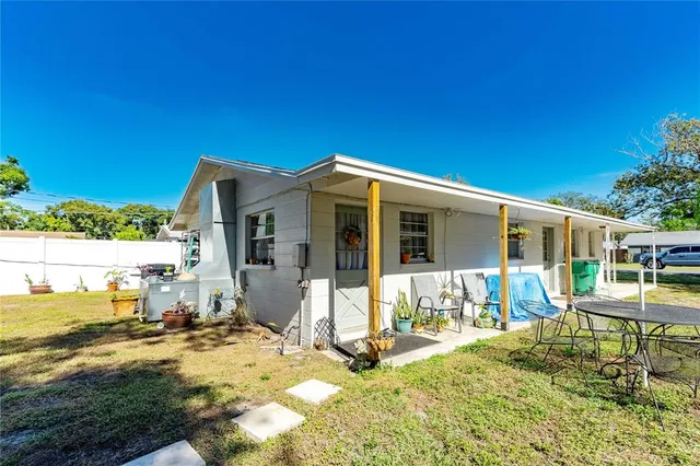 a view of a house with backyard porch and sitting area