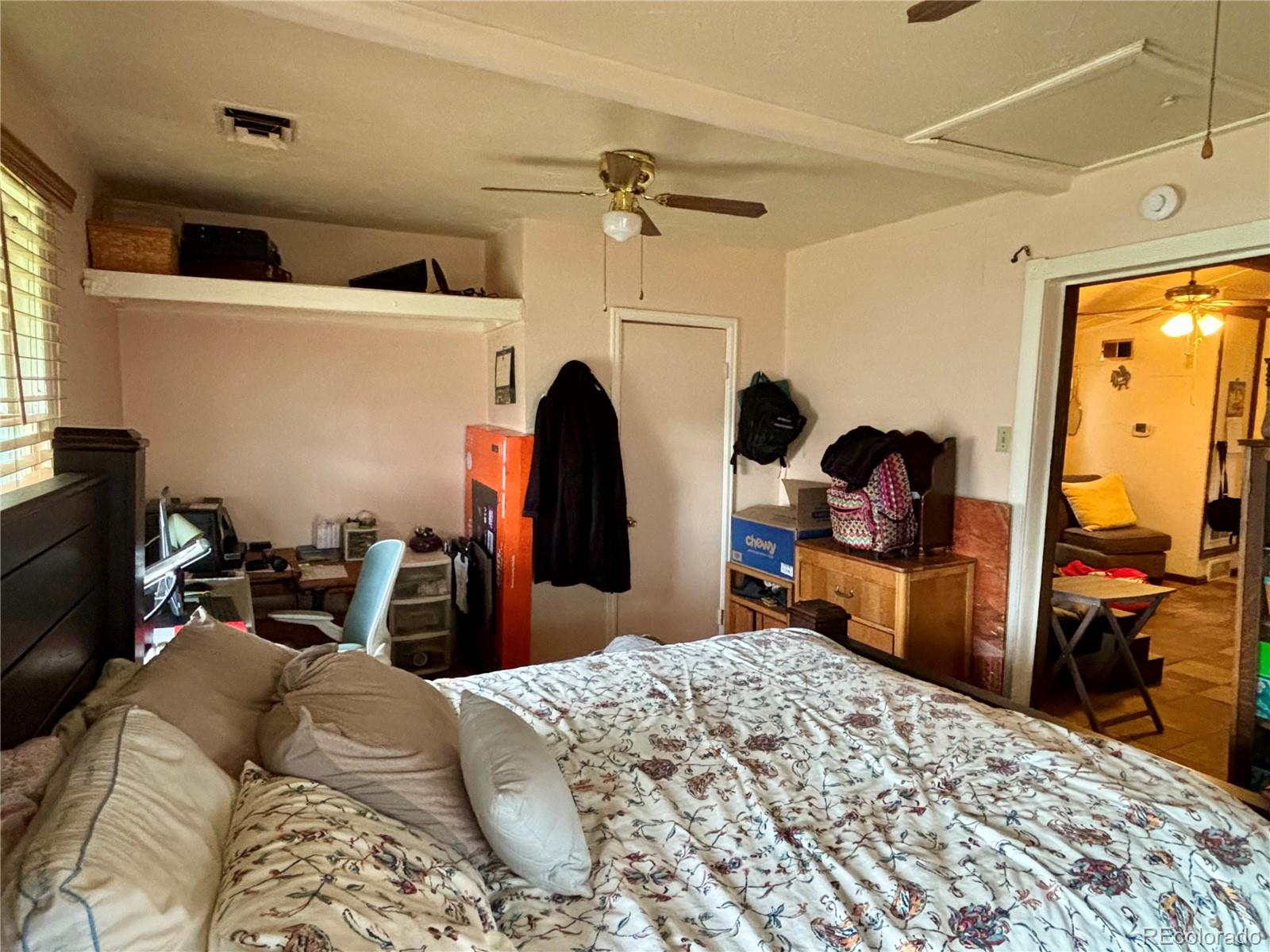 2568 Eaton Street Edgewater, CO 80214 - Photo 3 of 11 a bed room with a bed and a tv