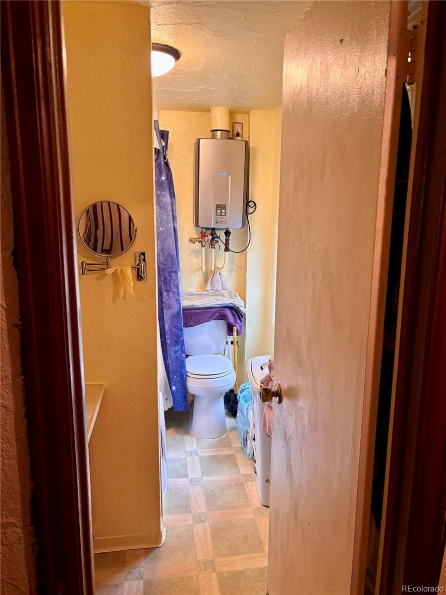 2568 Eaton Street Edgewater, CO 80214 - Photo 4 of 11 a bathroom with a sink and mirror