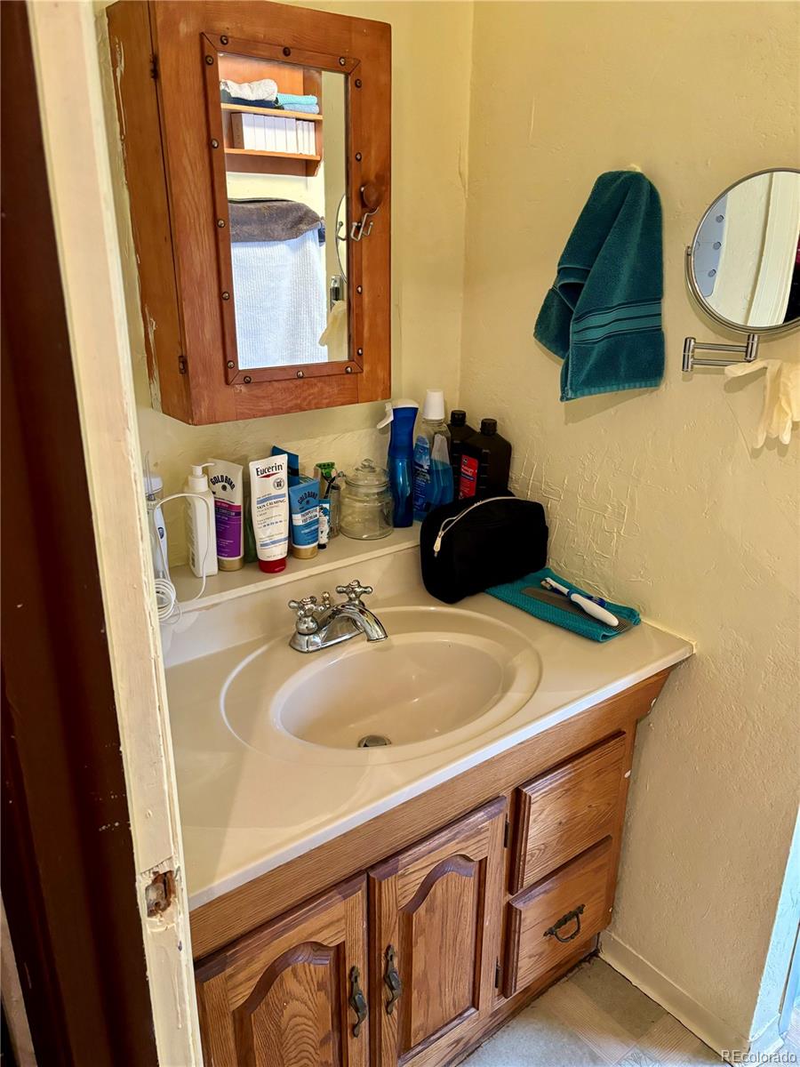 2568 Eaton Street Edgewater, CO 80214 - Photo 5 of 11 a bathroom with a sink and a mirror