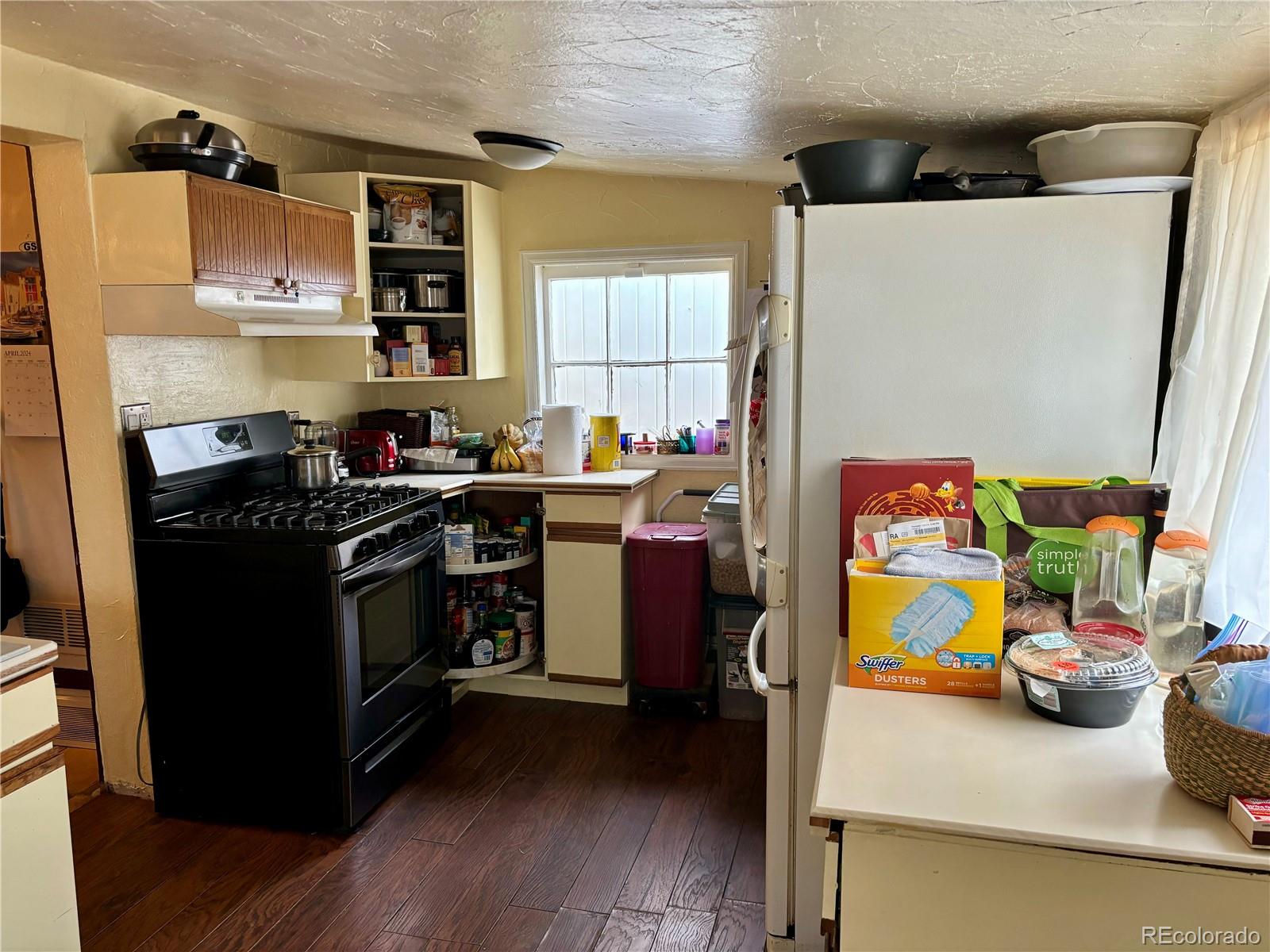 2568 Eaton Street Edgewater, CO 80214 - Photo 7 of 11 a kitchen with stainless steel appliances a stove a sink and a refrigerator
