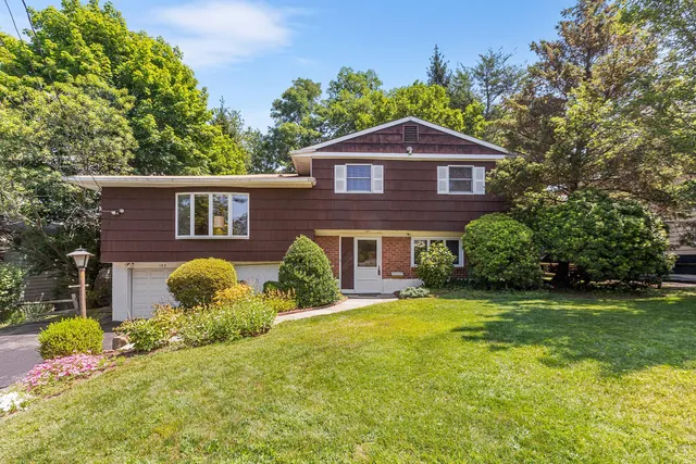 a front view of a house with garden