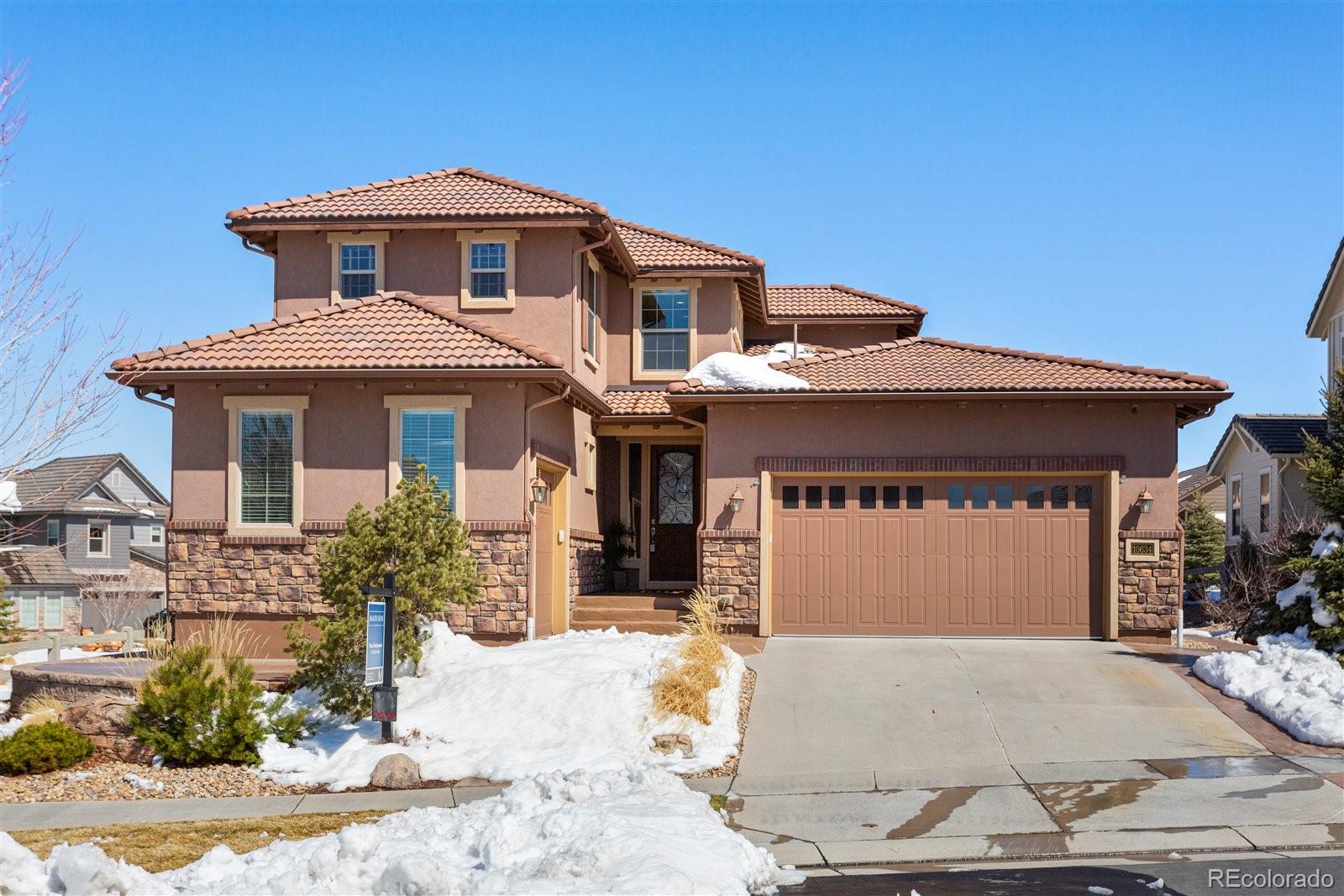10634 Sundial Rim Road Highlands Ranch, CO 80126 - Photo 1 of 40 a front view of a house with a yard