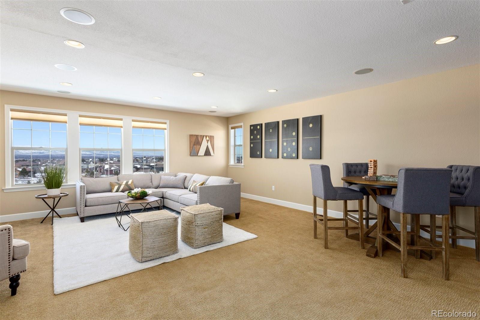 10634 Sundial Rim Road Highlands Ranch, CO 80126 - Photo 23 of 40 a living room with furniture and a large window