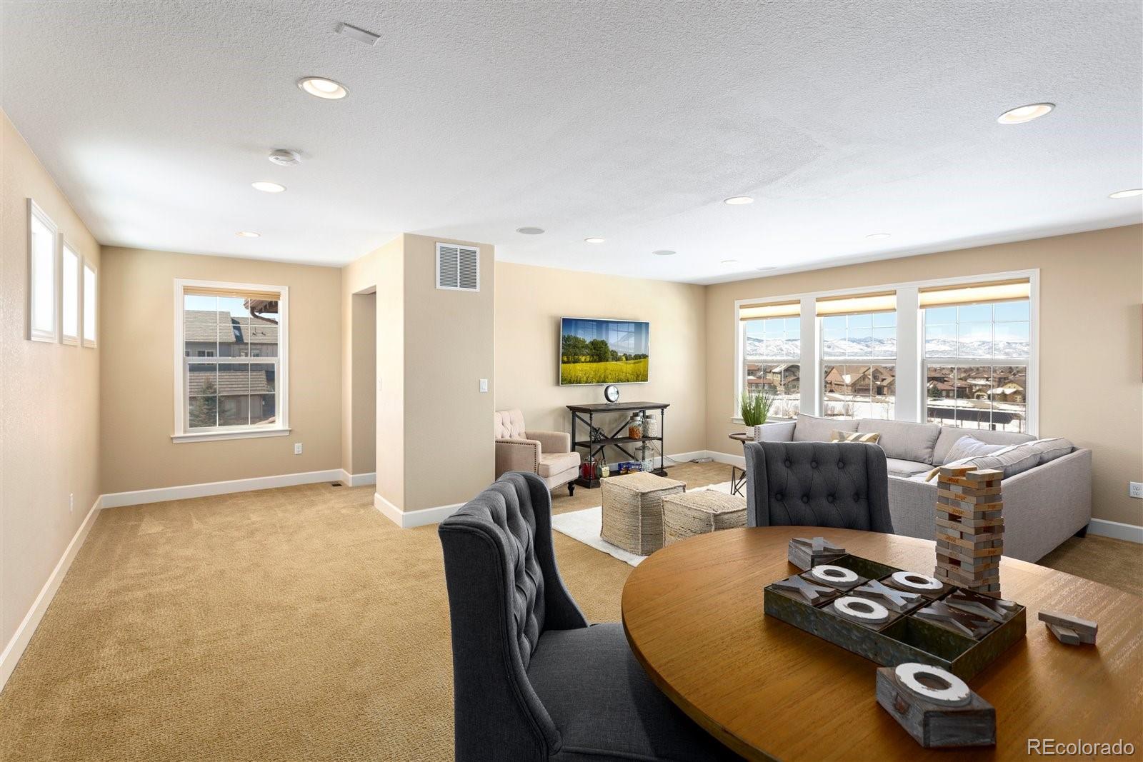 10634 Sundial Rim Road Highlands Ranch, CO 80126 - Photo 24 of 40 a living room with furniture and floor to ceiling windows