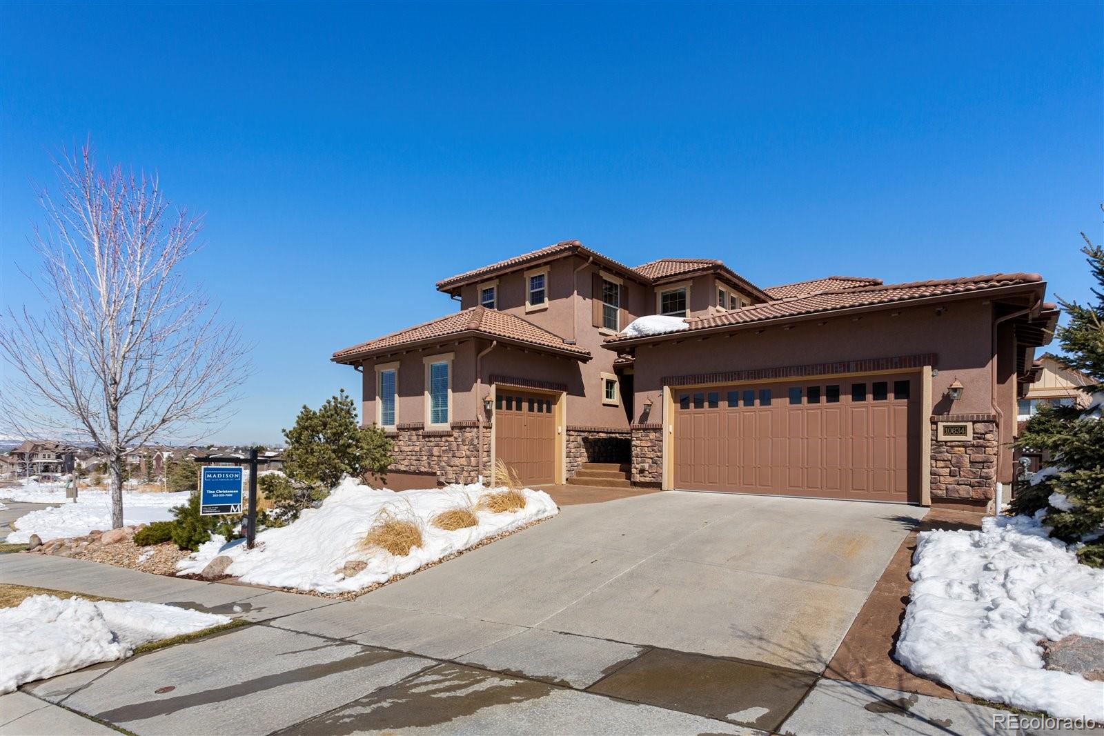 10634 Sundial Rim Road Highlands Ranch, CO 80126 - Photo 3 of 40 a front view of a house with a yard