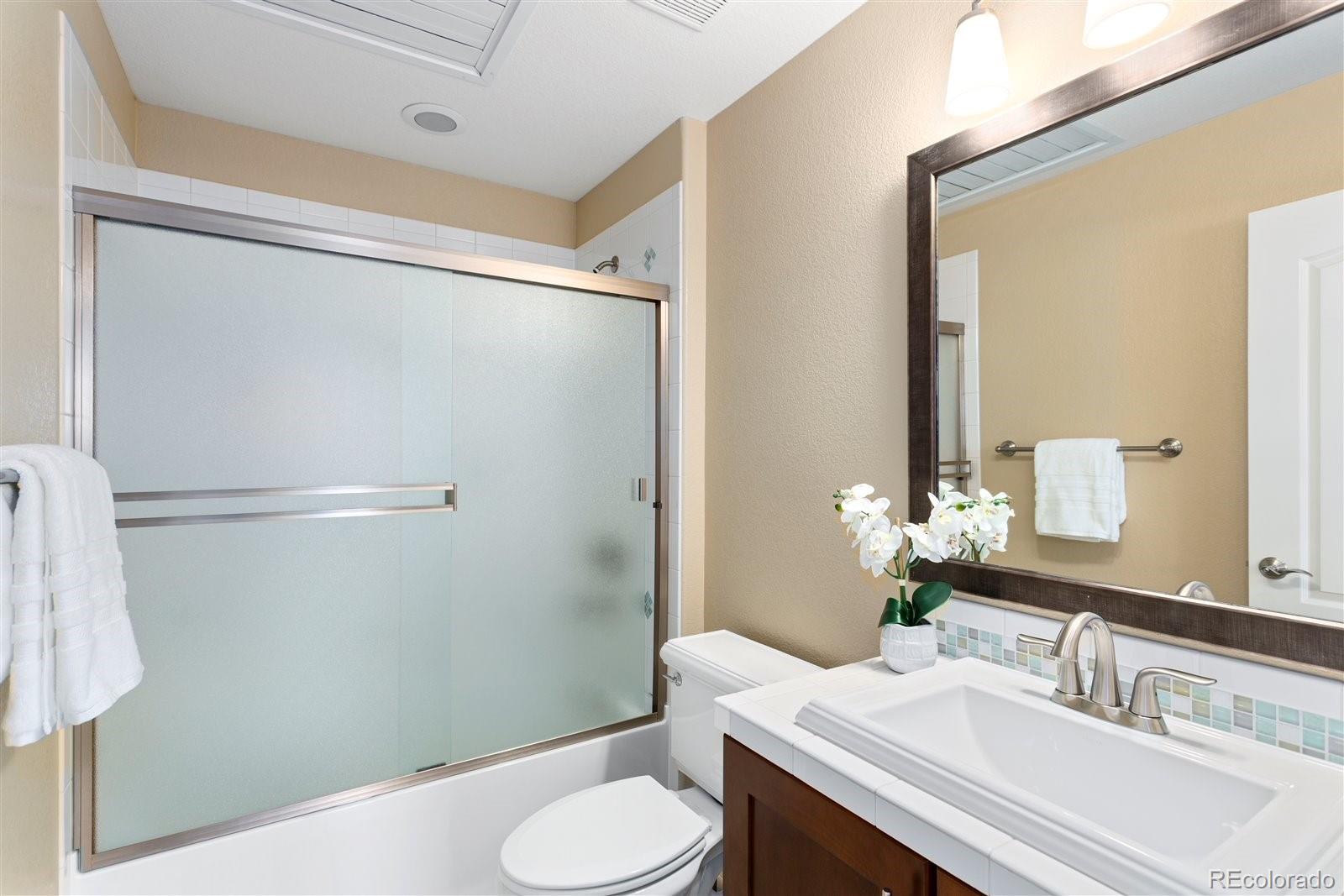 10634 Sundial Rim Road Highlands Ranch, CO 80126 - Photo 31 of 40 a bathroom with a sink toilet and shower