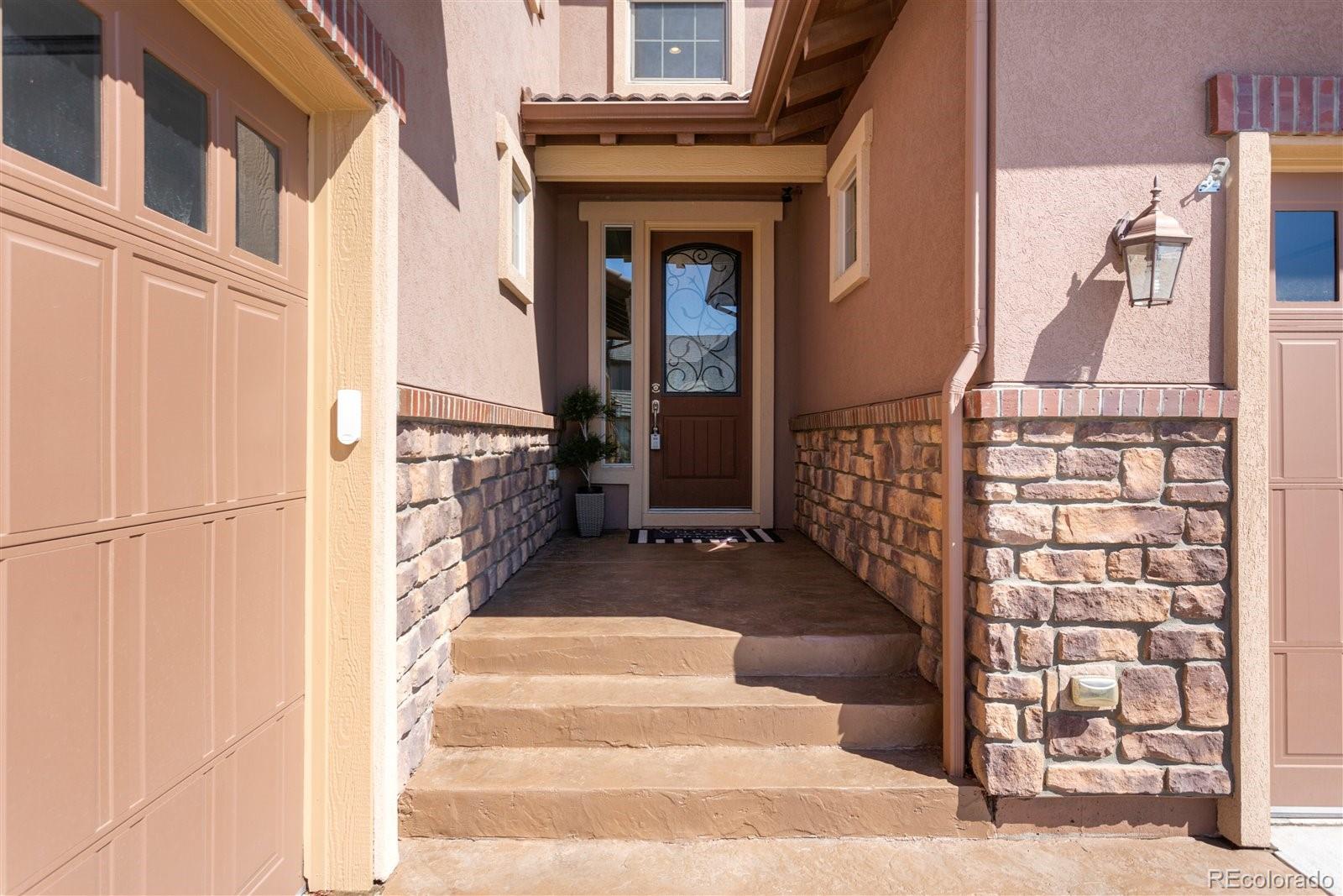 10634 Sundial Rim Road Highlands Ranch, CO 80126 - Photo 6 of 40 a view of a brick house with large windows