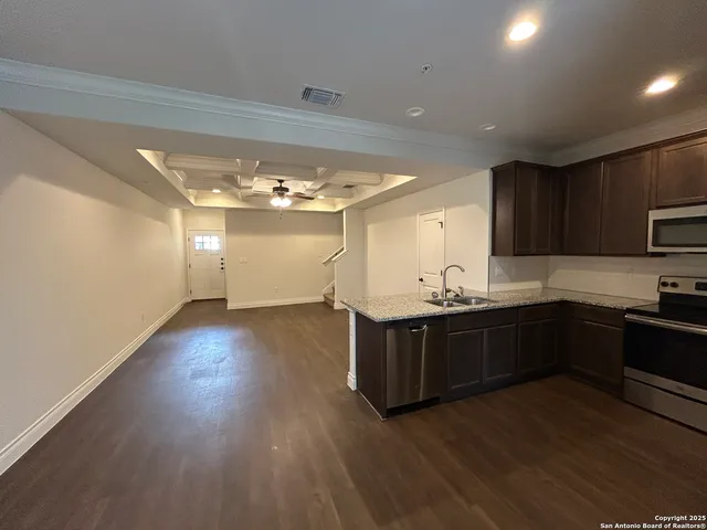 a kitchen with wooden floors and refrigerator
