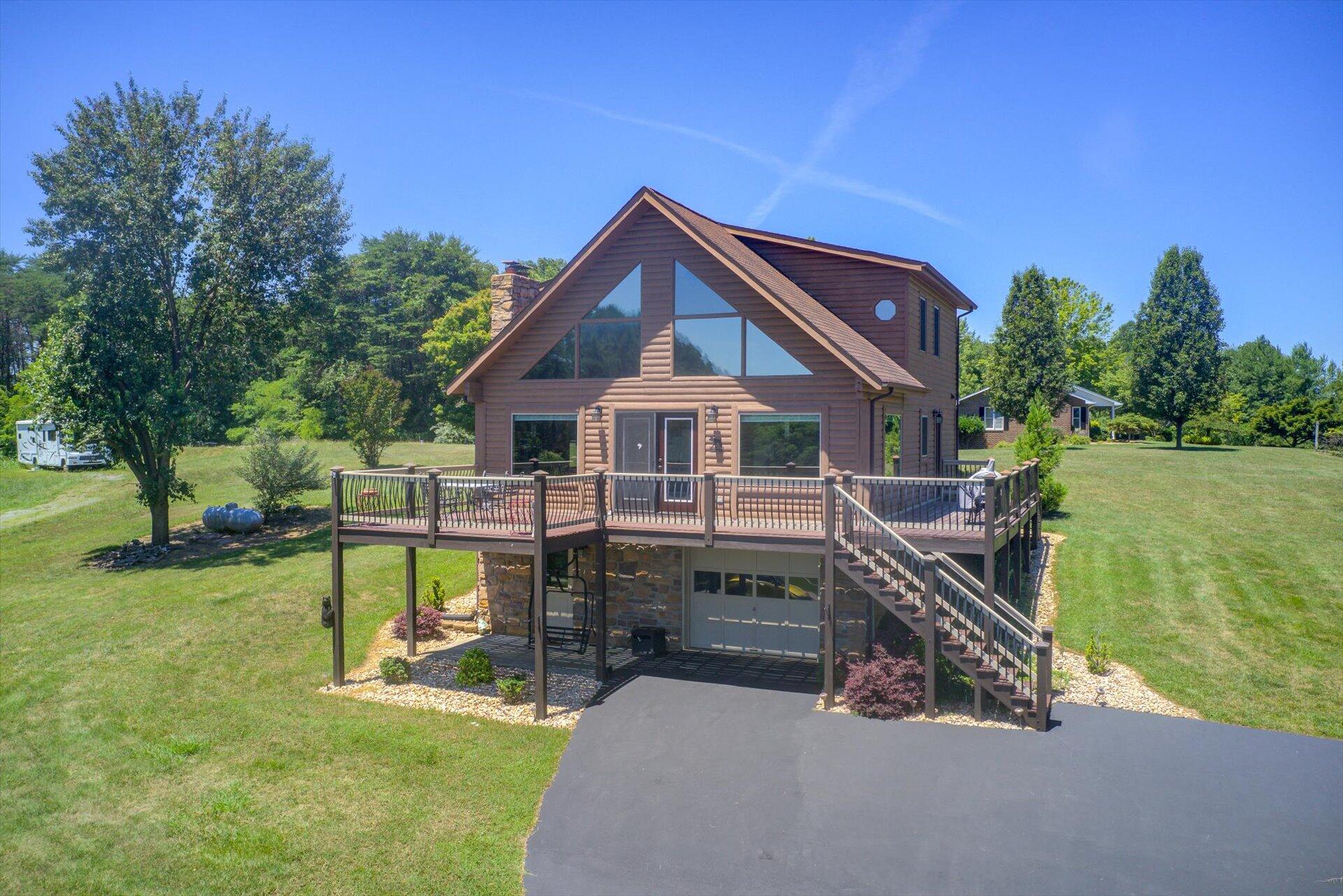 3499 Kemp Ford Road Union Hall, VA 24176 - Photo 3 of 52 a front view of a house with a garden and lake view