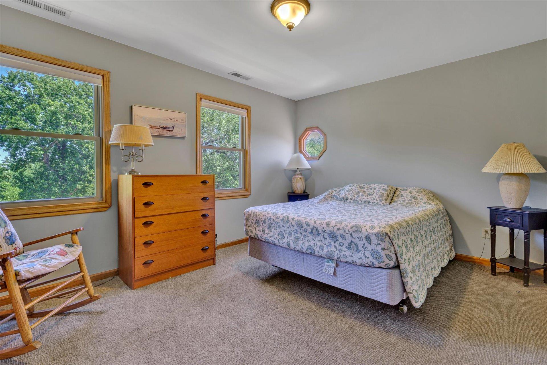 3499 Kemp Ford Road Union Hall, VA 24176 - Photo 23 of 52 a bedroom with a bed and a lamp next to a window