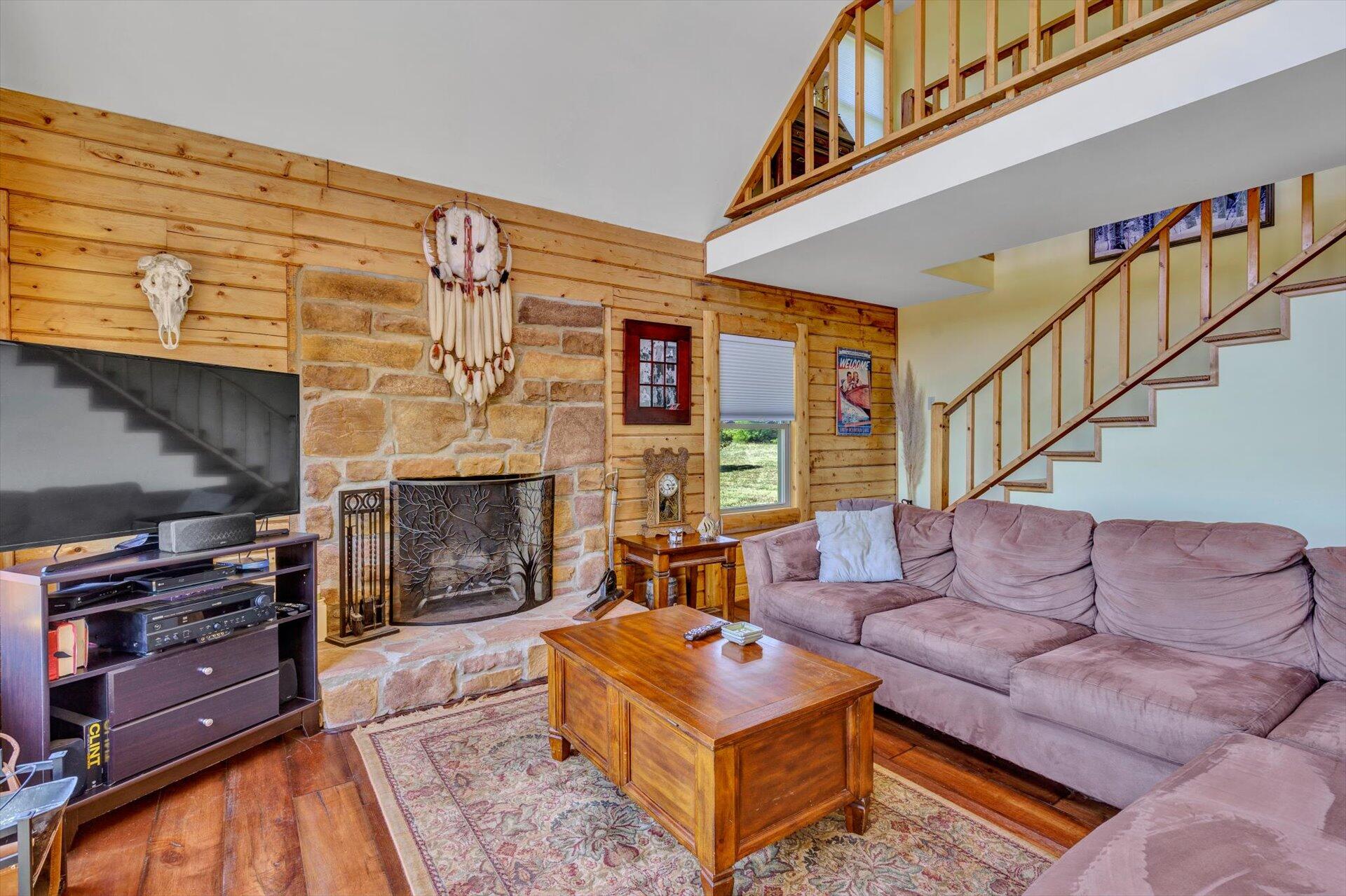 3499 Kemp Ford Road Union Hall, VA 24176 - Photo 7 of 52 a living room with furniture a fireplace and a book shelf