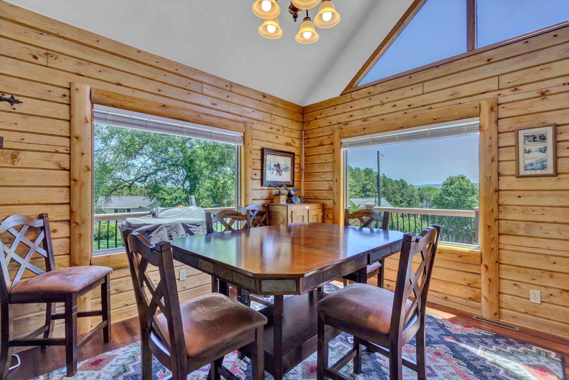 3499 Kemp Ford Road Union Hall, VA 24176 - Photo 9 of 52 a dining room with furniture a rug and a floor to ceiling window
