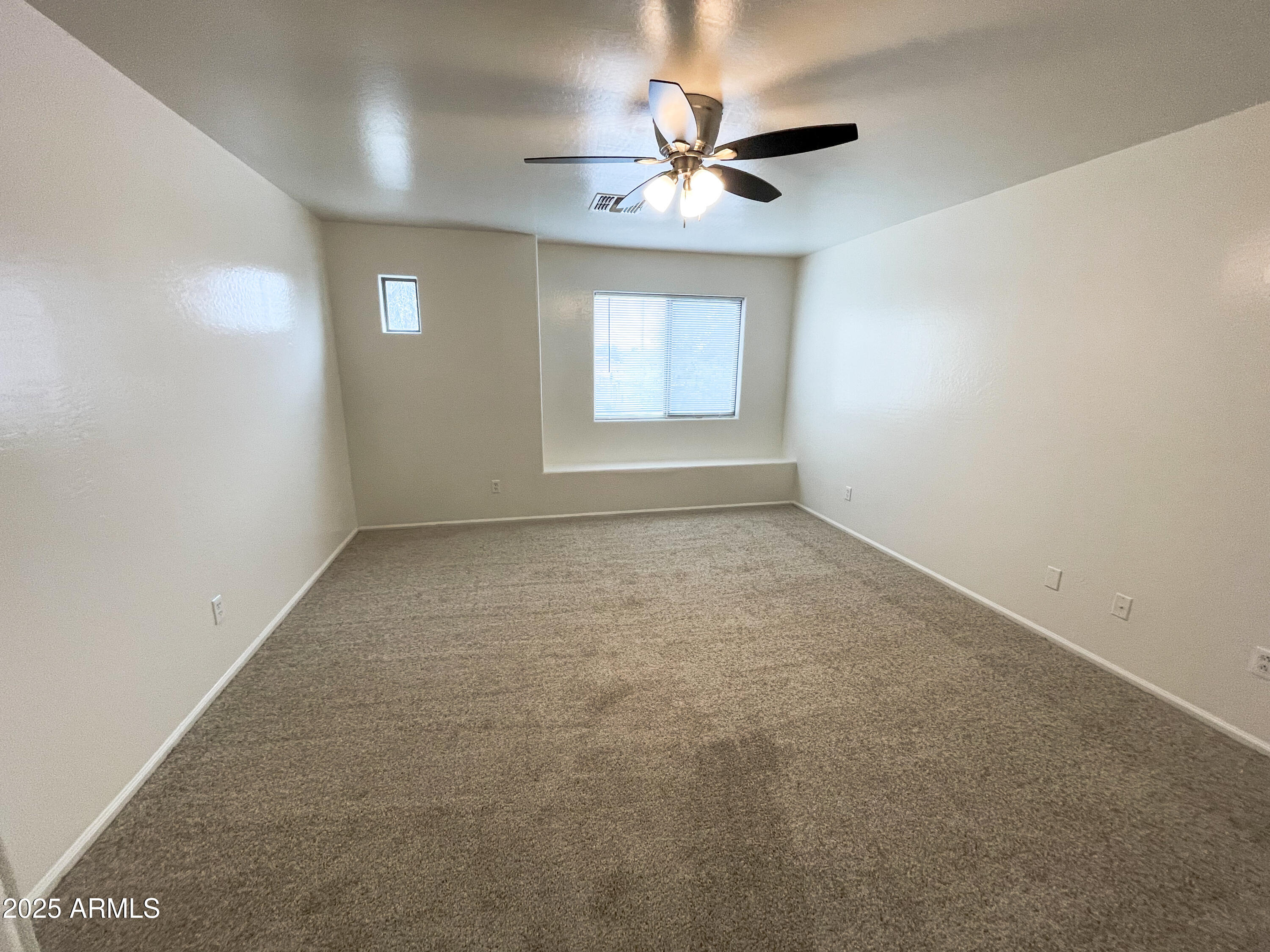41389 Hopper Drive Maricopa, AZ 85138 - Photo 13 of 17 an empty room with a window and a fan