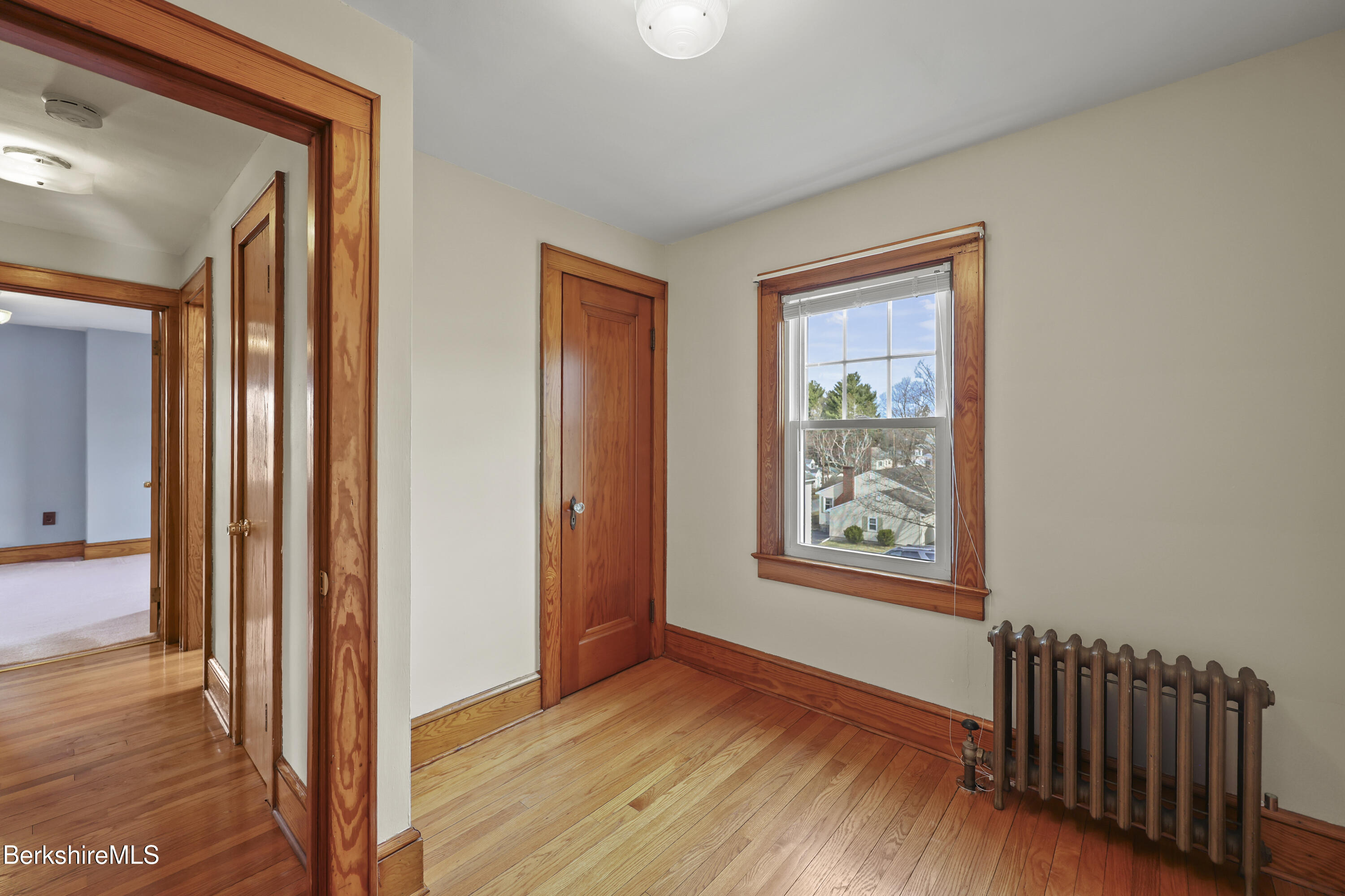 12 Sherrill Avenue Pittsfield, MA 01201 - Photo 27 of 40 a view of an empty room with wooden floor and a window