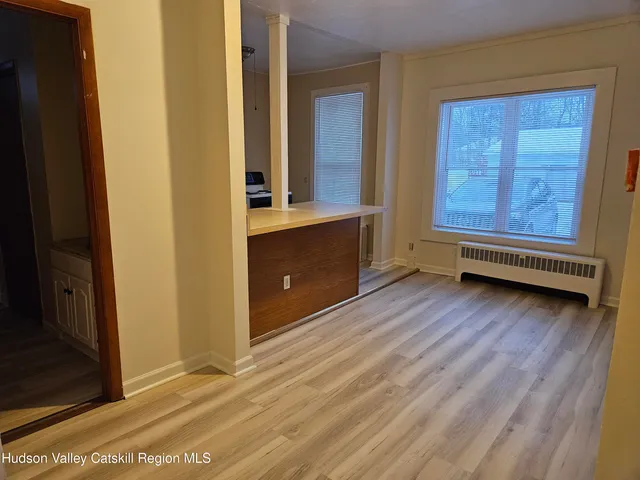 a view of front door with wooden floor