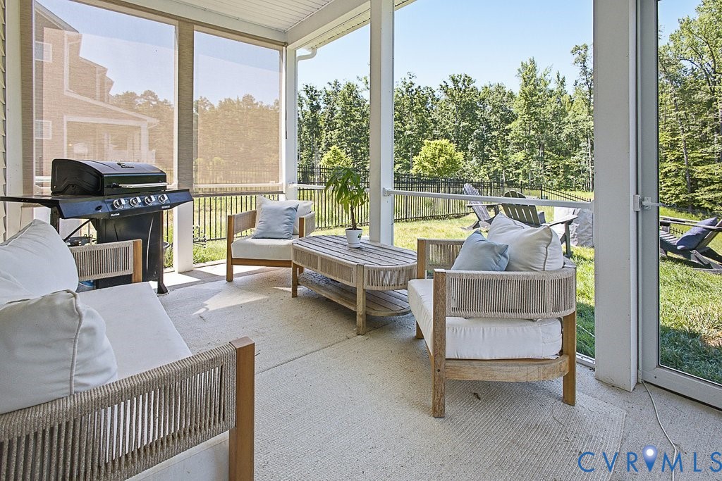18517 Palisades Ridge Moseley, VA 23120 - Photo 33 of 55 a living room with furniture and a floor to ceiling window
