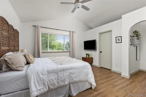 a bedroom with a bed and a flat screen tv