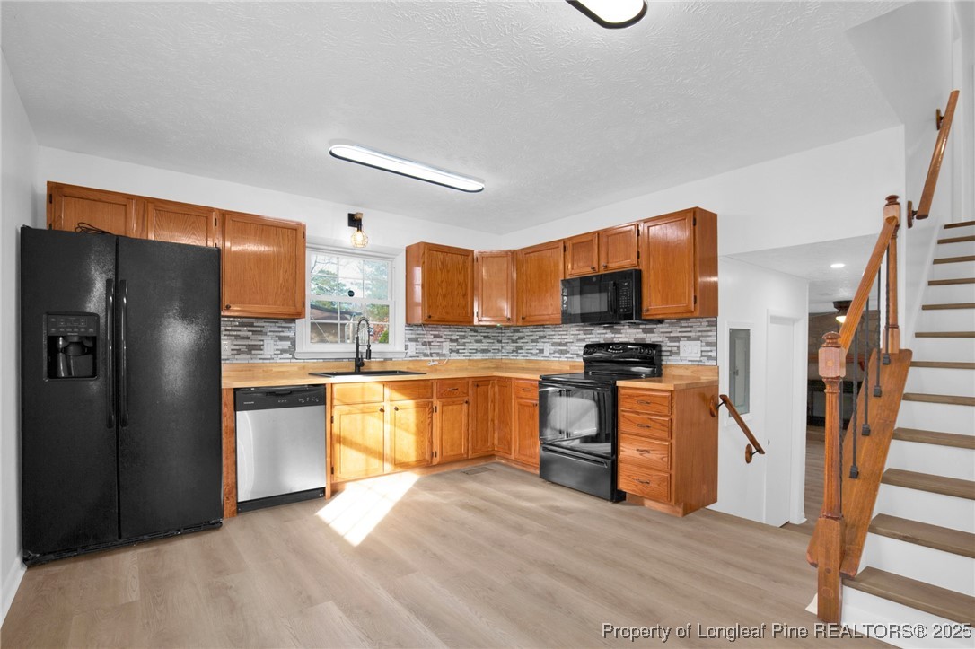 6806 Beaver Stone Road Fayetteville, NC 28314 - Photo 13 of 42 a kitchen with stainless steel appliances granite countertop a refrigerator stove top oven and sink