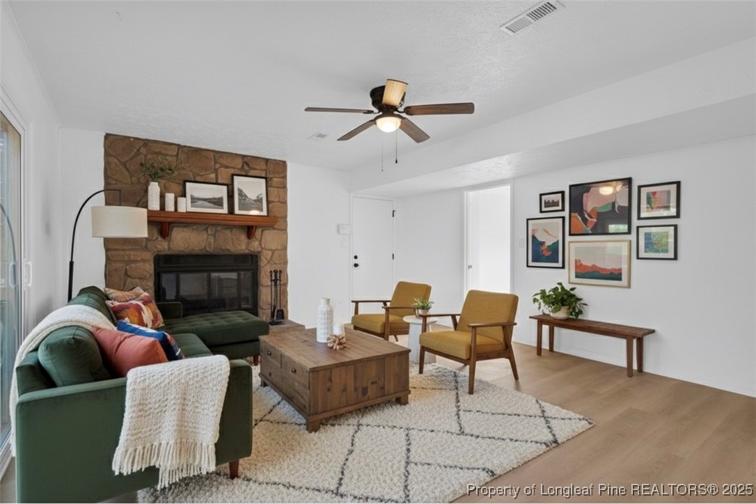 6806 Beaver Stone Road Fayetteville, NC 28314 - Photo 20 of 42 a living room with furniture and a fireplace