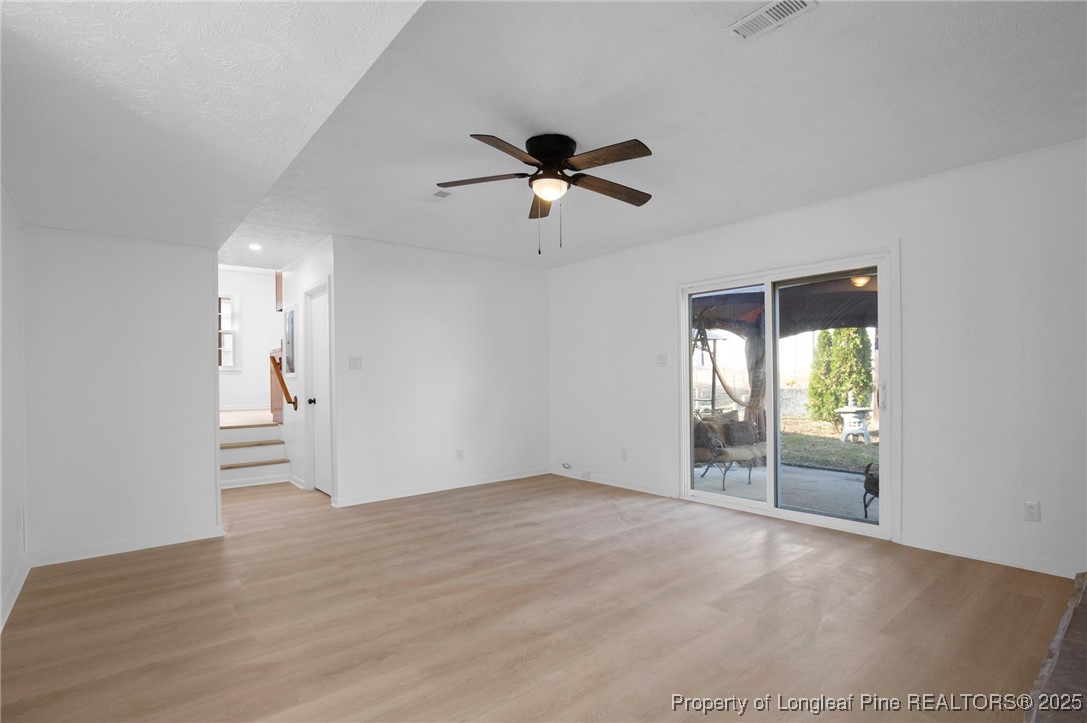 6806 Beaver Stone Road Fayetteville, NC 28314 - Photo 21 of 42 a view of empty room with wooden floor and fan