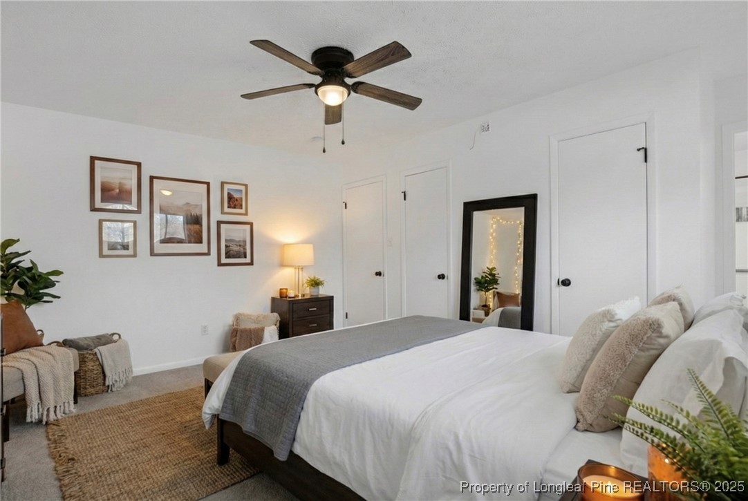 6806 Beaver Stone Road Fayetteville, NC 28314 - Photo 23 of 42 a bedroom with a large bed and a chandelier