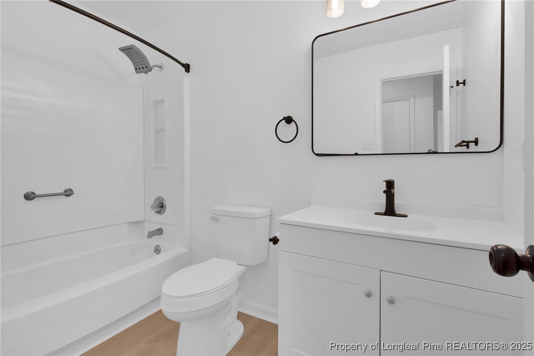 6806 Beaver Stone Road Fayetteville, NC 28314 - Photo 28 of 42 a bathroom with a sink a toilet and a mirror